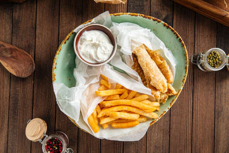 Fish and chips dish with potato fries