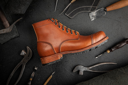 Handcrafted brown leather shoe with cobbler tools