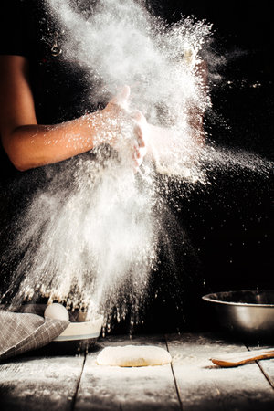 Baker hand with flour pizza preparationの写真素材