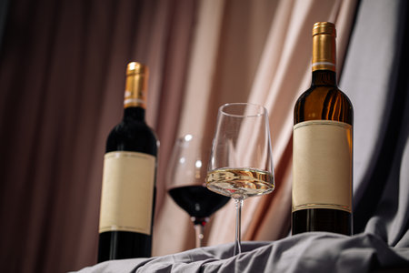 Two bottles and glasses of red and white wineの写真素材