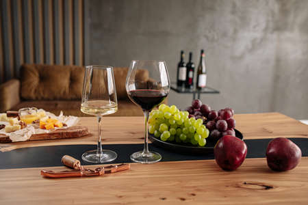 Wine glasses with appetizers on tableの写真素材