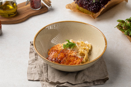 Portion of fettuccine pasta with grilled chickenの写真素材