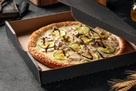 Take away packed pizza with chicken and zucchiniの写真素材
