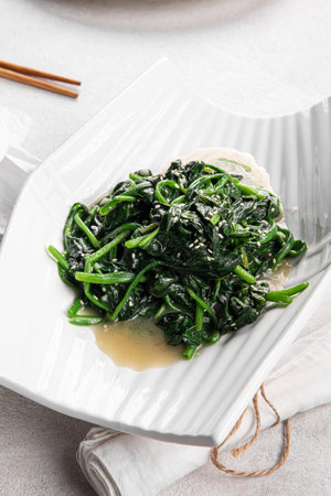 Portion of restaurant asian garlic spinach saladの写真素材