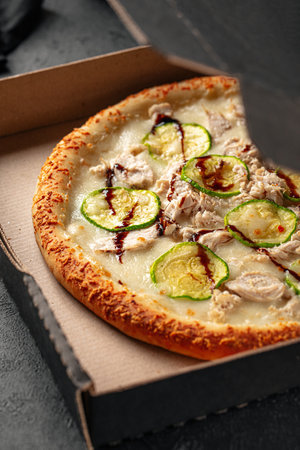Take away packed pizza with chicken and zucchiniの写真素材