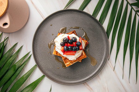 Portion of sweet belgian waffles with berriesの写真素材