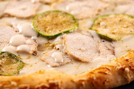 Closeup on chicken pizza with zucchiniの写真素材