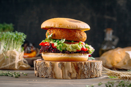Vegan falafel burger with vegetables on the boardの写真素材