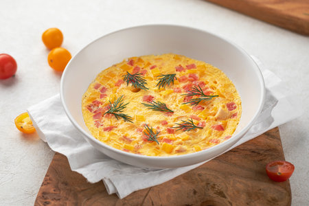 Portion of gourmet tender omelette with ham