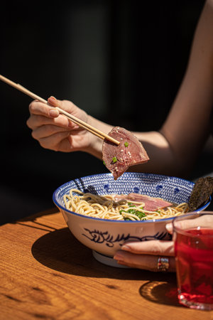 Woman eating japanese ramen noodle soupの写真素材