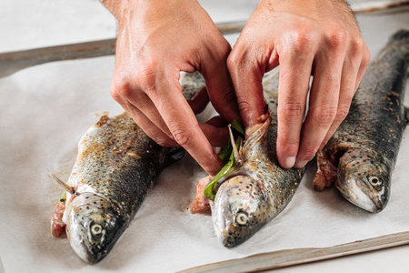 Chef stuffs fish for cookingの写真素材