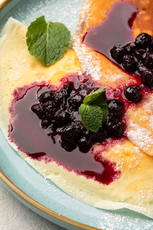 Portion of sweet crepe blini pancakes with jamの写真素材