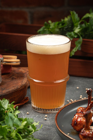 Glass of beer on grey tableの写真素材