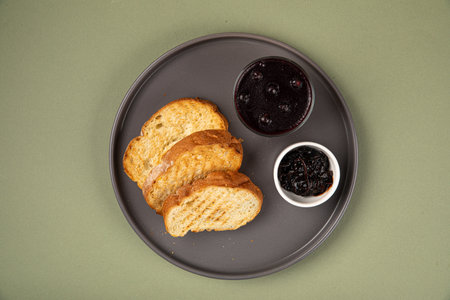 Portion of toast with currant jamの写真素材