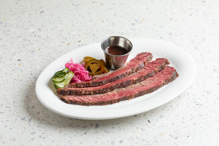 Sliced beef brisket with pickles and sauceの写真素材