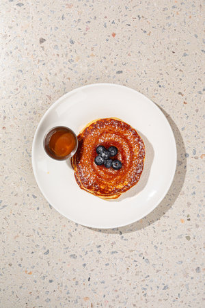Portion of pancakes with blueberries and sauceの写真素材