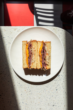 Portion of sandwich with pickles on the cafe tableの写真素材