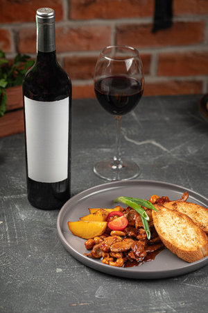 Sweet and sour pork meat with potato with wineの写真素材