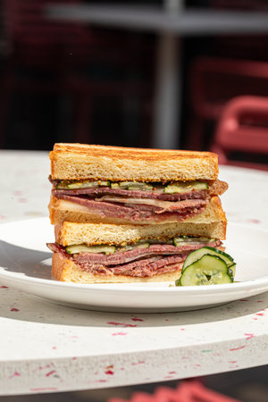 Portion of sandwich with pickles on the cafe tableの写真素材