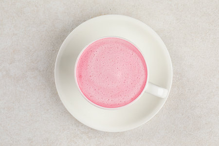 Cup of pink cappuccino coffee drinkの写真素材