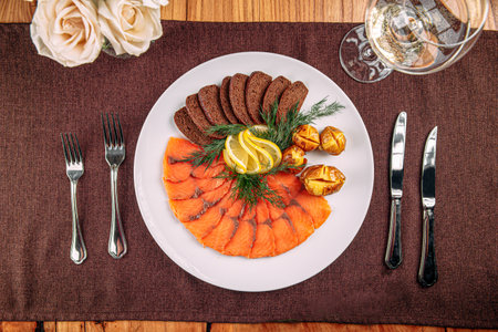 Salmon platter appetizer with bread and potatoの写真素材