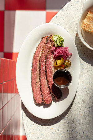 Sliced beef brisket with pickles and sauceの写真素材