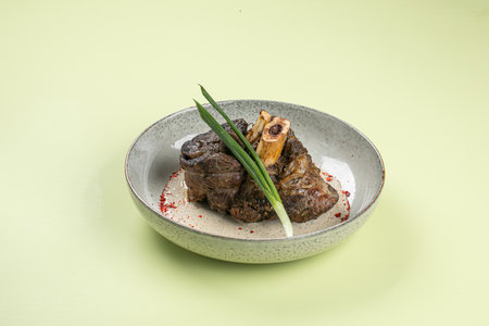 Portion of baked beef shank with pepper sauceの写真素材