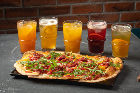 Tarte flambee pizza with sausages and lemonadesの写真素材