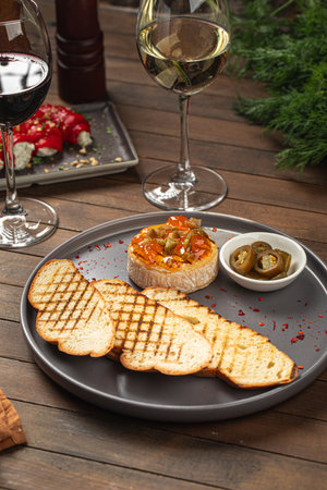 Portion of baked brie with jalapeno and toastの写真素材