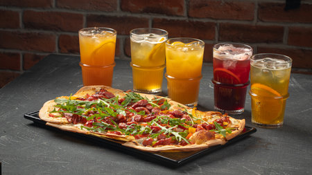 Tarte flambee pizza with sausages and lemonadesの写真素材