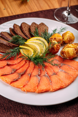 Salmon platter appetizer with bread and potatoの写真素材