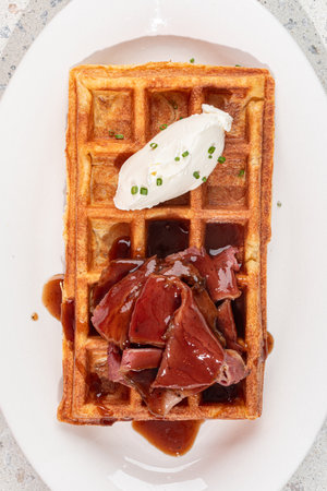 Portion of waffle with brisket and cream cheeseの写真素材