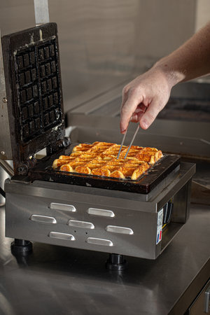 Cooking belgian waffles in the cafe kitchenの写真素材