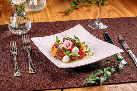 Portion of cherry tomato salad with mozzarellaの写真素材
