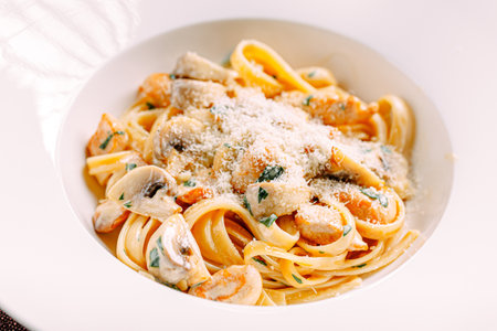Portion of fettuccine alfredo pasta with chickenの写真素材