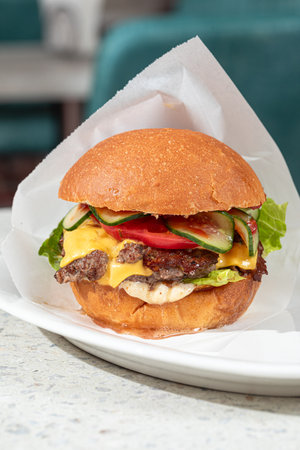 Portion of appetizing american cheeseburgerの写真素材