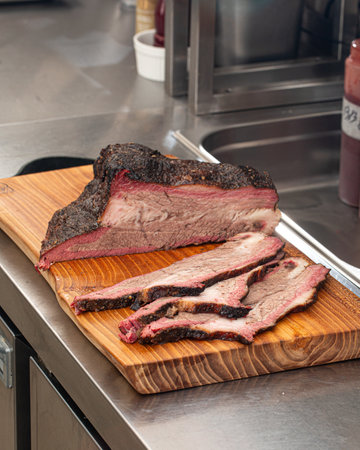 Sliced american beef brisket on a wooden boardの写真素材