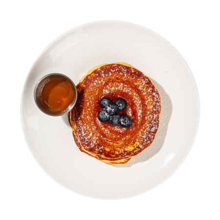 Portion of pancakes with blueberries and sauceの写真素材