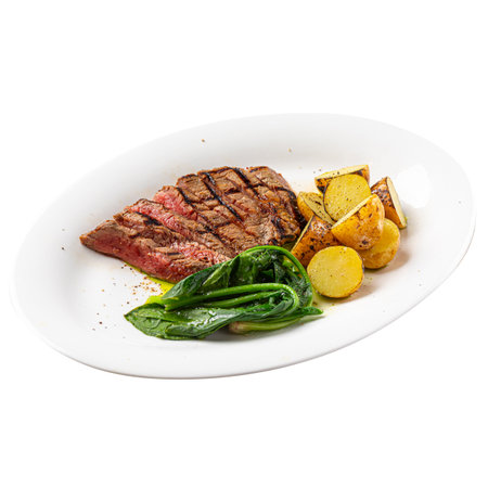 Portion of grilled top blade steak with potatoesの写真素材