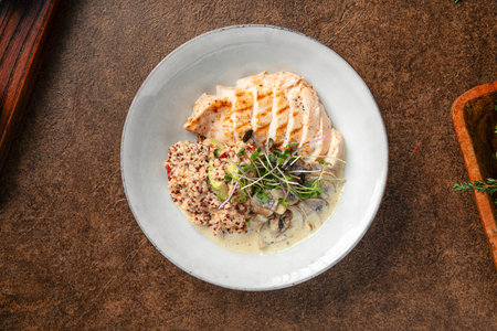 Healthy quinoa dish with creamy chicken breastの写真素材