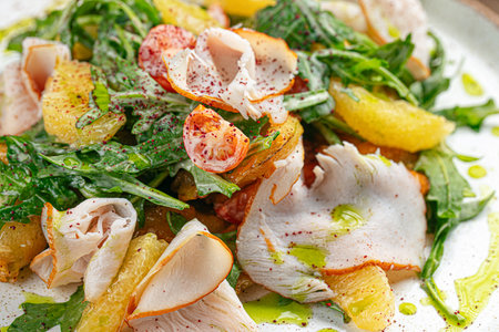 Smoked turkey salad with arugula and orangesの写真素材