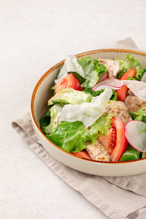 Portion of vegetables salad with chickenの写真素材