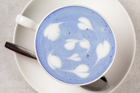 Portion of blue matcha latte in white cupの写真素材