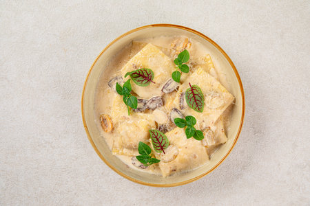 Portion of gourmet ravioli with cream sauceの写真素材
