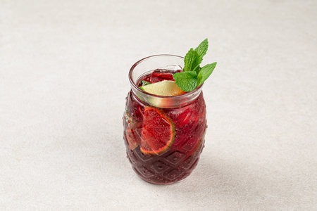Glass of fresh berry tea with mint and iceの写真素材