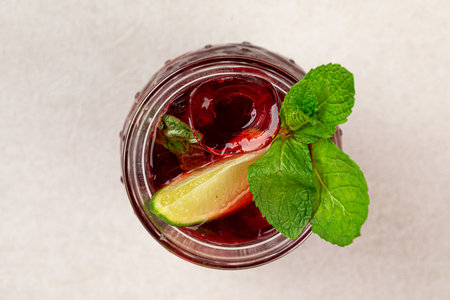 Glass of fresh berry tea with mint and iceの写真素材