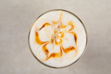 Portion of coffee latte with caramel syrupの写真素材
