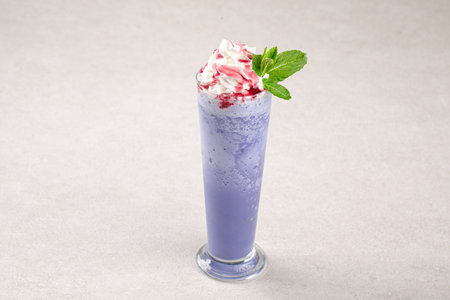 Portion of blueberry milkshake with whipped creamの写真素材