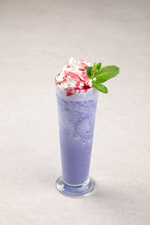 Portion of blueberry milkshake with whipped creamの写真素材