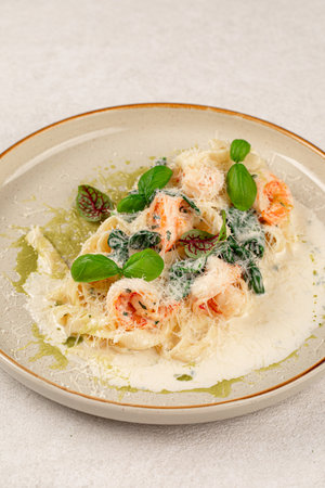 Portion of fettuccine with shrimps in cream sauceの写真素材